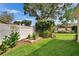 Lush yard with a garden bed and white fence offers a private outdoor space at 905 Balsamina Dr, Brandon, FL 33510