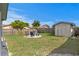 Backyard area with a cozy firepit, chairs and manicured white rock at 9128 Suffield Ct, Tampa, FL 33615