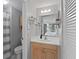 Updated bathroom features a modern vanity, decorative mirror, and great lighting at 9128 Suffield Ct, Tampa, FL 33615