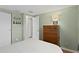 Cozy bedroom featuring hardwood floors, dresser, and access to closet and bathroom at 9128 Suffield Ct, Tampa, FL 33615