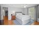 Cozy bedroom featuring ceiling fan, hardwood floors, and a serene color palette at 9128 Suffield Ct, Tampa, FL 33615