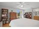 Bedroom featuring a large dresser, sliding glass doors to back yard and hardwood floors at 9128 Suffield Ct, Tampa, FL 33615
