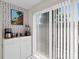 Bright breakfast nook featuring custom wallpaper, sliding glass door, and updated cabinetry at 9128 Suffield Ct, Tampa, FL 33615