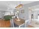 Charming dining area with a modern light fixture adjacent to a living room and kitchen at 9128 Suffield Ct, Tampa, FL 33615