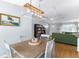Well-lit dining area with modern light fixture and view of the front room at 9128 Suffield Ct, Tampa, FL 33615
