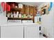 Functional laundry room with washer, dryer, and shelving for storage at 9128 Suffield Ct, Tampa, FL 33615