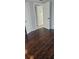 Bedroom featuring stylish hardwood floors with a view of a room opening at 9307 N 16Th St, Tampa, FL 33612
