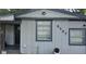 View of exterior with light gray siding, dark trim, and house number 9307 at 9307 N 16Th St, Tampa, FL 33612