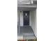 A close-up shot of the front door, steps, and gray railings of the porch at 9307 N 16Th St, Tampa, FL 33612