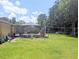 The backyard features lush green grass and a well-maintained outdoor space at 7535 Cypress Knoll Dr, New Port Richey, FL 34653