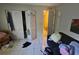 A bedroom featuring white bi-fold closet doors and neutral-colored walls at 7535 Cypress Knoll Dr, New Port Richey, FL 34653