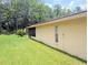 The exterior features lush green grass, mature trees, and a well-maintained exterior at 7535 Cypress Knoll Dr, New Port Richey, FL 34653