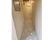 A hallway featuring beige walls and a white tile floor at 7535 Cypress Knoll Dr, New Port Richey, FL 34653