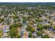 Strategic aerial view of the residence with visible rooftops, complemented by a leafy neighborhood backdrop and distant skyline at 3300 52Nd N St, St Petersburg, FL 33710
