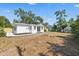 Backyard featuring a well-maintained lawn, modern patio, and mature trees at 3300 52Nd N St, St Petersburg, FL 33710