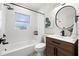 Updated bathroom featuring modern fixtures, a bathtub and shower combo, and a stylish vanity at 3300 52Nd N St, St Petersburg, FL 33710