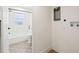 View of the updated bathroom featuring a shower, a tub, and connections for a washer and dryer at 3300 52Nd N St, St Petersburg, FL 33710