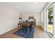 Bright dining room with wood table, modern decor, and sliding glass doors leading to the outdoors at 3300 52Nd N St, St Petersburg, FL 33710