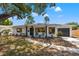 Charming home with a well-manicured lawn, black trimmed windows, and welcoming front porch at 3300 52Nd N St, St Petersburg, FL 33710