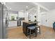 Modern kitchen island with bar stool seating, stainless steel appliances, and white cabinetry at 3300 52Nd N St, St Petersburg, FL 33710
