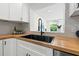 Close-up of a kitchen sink with stylish fixtures and a butcher block countertop at 3300 52Nd N St, St Petersburg, FL 33710