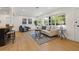 Sun-filled living room boasts large windows, stylish furnishings, and wood flooring for a comfortable living space at 3300 52Nd N St, St Petersburg, FL 33710