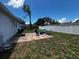 Spacious backyard with a patio area and fire pit surrounded by lush grass and privacy fencing at 103 Inwood Cir, Brandon, FL 33510