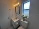 Clean bathroom with a modern vanity, framed mirror, and fresh decor at 103 Inwood Cir, Brandon, FL 33510