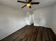 Cozy bedroom with hardwood floors and a ceiling fan at 103 Inwood Cir, Brandon, FL 33510