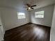 Cozy bedroom with hardwood floors and natural light from two windows at 103 Inwood Cir, Brandon, FL 33510