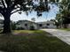 Charming home with a well-manicured lawn and lush landscaping, enhancing curb appeal at 103 Inwood Cir, Brandon, FL 33510