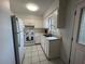 Bright kitchen with white cabinets, modern appliances, and neutral countertops and tile floor at 103 Inwood Cir, Brandon, FL 33510