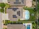 Aerial view of a home with a pool, solar panels, and well-maintained landscaping at 10596 Lake Seminole Ter, Seminole, FL 33772