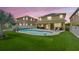 Beautiful backyard featuring a covered patio, pool, and well-maintained artificial grass at 10596 Lake Seminole Ter, Seminole, FL 33772