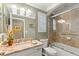 Well-appointed bathroom with a marble vanity, walk-in shower, and a soaking tub at 10596 Lake Seminole Ter, Seminole, FL 33772