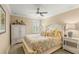 Relaxing bedroom with a comfortable bed, shuttered window, and stylish decor at 10596 Lake Seminole Ter, Seminole, FL 33772