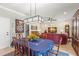 Dining room with a dark wooden table set for six and a view into the bright and airy living room at 10596 Lake Seminole Ter, Seminole, FL 33772