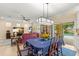 Open concept with view to the dining room, kitchen, and living room with a cozy red leather couch at 10596 Lake Seminole Ter, Seminole, FL 33772