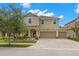 Charming two-story home with a three-car garage, landscaped yard, and a beautiful brick driveway at 10596 Lake Seminole Ter, Seminole, FL 33772