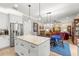 Open kitchen layout with island seating flowing into the dining area and living room at 10596 Lake Seminole Ter, Seminole, FL 33772