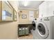 Functional laundry room featuring modern appliances, counter space, and storage solutions at 10596 Lake Seminole Ter, Seminole, FL 33772