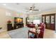 Comfortable living room with a red leather sofa, display cabinet, and a large television at 10596 Lake Seminole Ter, Seminole, FL 33772