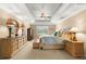 Spacious main bedroom with a tray ceiling, decorative lamps, and neutral color palette at 10596 Lake Seminole Ter, Seminole, FL 33772
