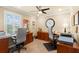 Spacious home office with built-in desks, dual workstations, and ample storage at 10596 Lake Seminole Ter, Seminole, FL 33772