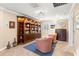 Well-lit sitting room featuring a built-in bookcase and a pair of comfortable chairs at 10596 Lake Seminole Ter, Seminole, FL 33772