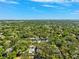 Aerial view of a sprawling neighborhood showcasing lush trees and beautiful blue skies at 1120 43Rd N Ave, St Petersburg, FL 33703