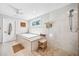 Bright bathroom features a modern soaking tub and glass-enclosed shower with neutral tiling at 1120 43Rd N Ave, St Petersburg, FL 33703