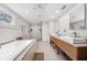 Bright, modern bathroom with double sinks, a luxurious tub, and glass-enclosed shower for a spa-like retreat at 1120 43Rd N Ave, St Petersburg, FL 33703