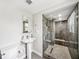 Modern bathroom with a pedestal sink and glass enclosed shower with gray tile at 1120 43Rd N Ave, St Petersburg, FL 33703