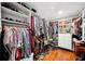 Walk-in closet with built-in shelves and hanging racks on hardwood floors at 1120 43Rd N Ave, St Petersburg, FL 33703